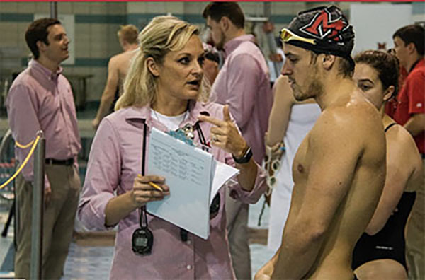 Miami men's swimming and diving coach Hollie Bonewit-Cron talks to a swimmer.
