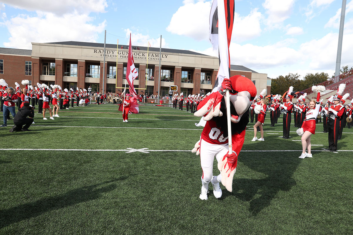Miami mascot Swoop leading the RedHawks onto the field