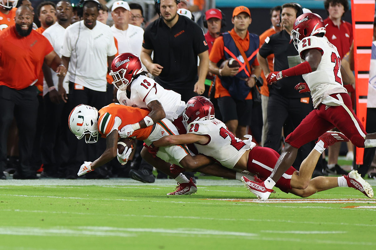Miami's Raion Strader (13) and Silas Walters (29) make a tackle in the season opener against the University of Miami on Sept. 1.