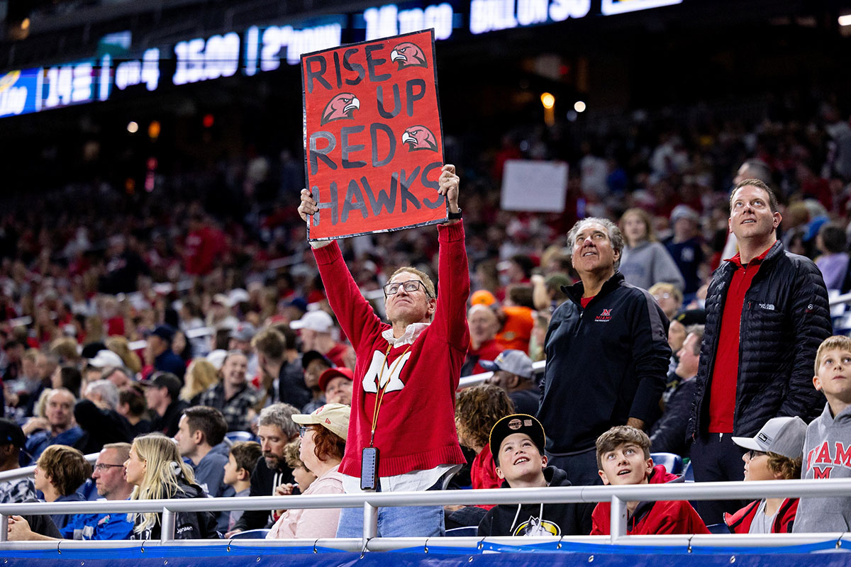 Miami football fan holds a sign at Ford Field