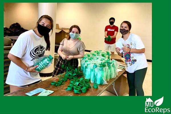 ecorep booth with students handing out reusable water bottles