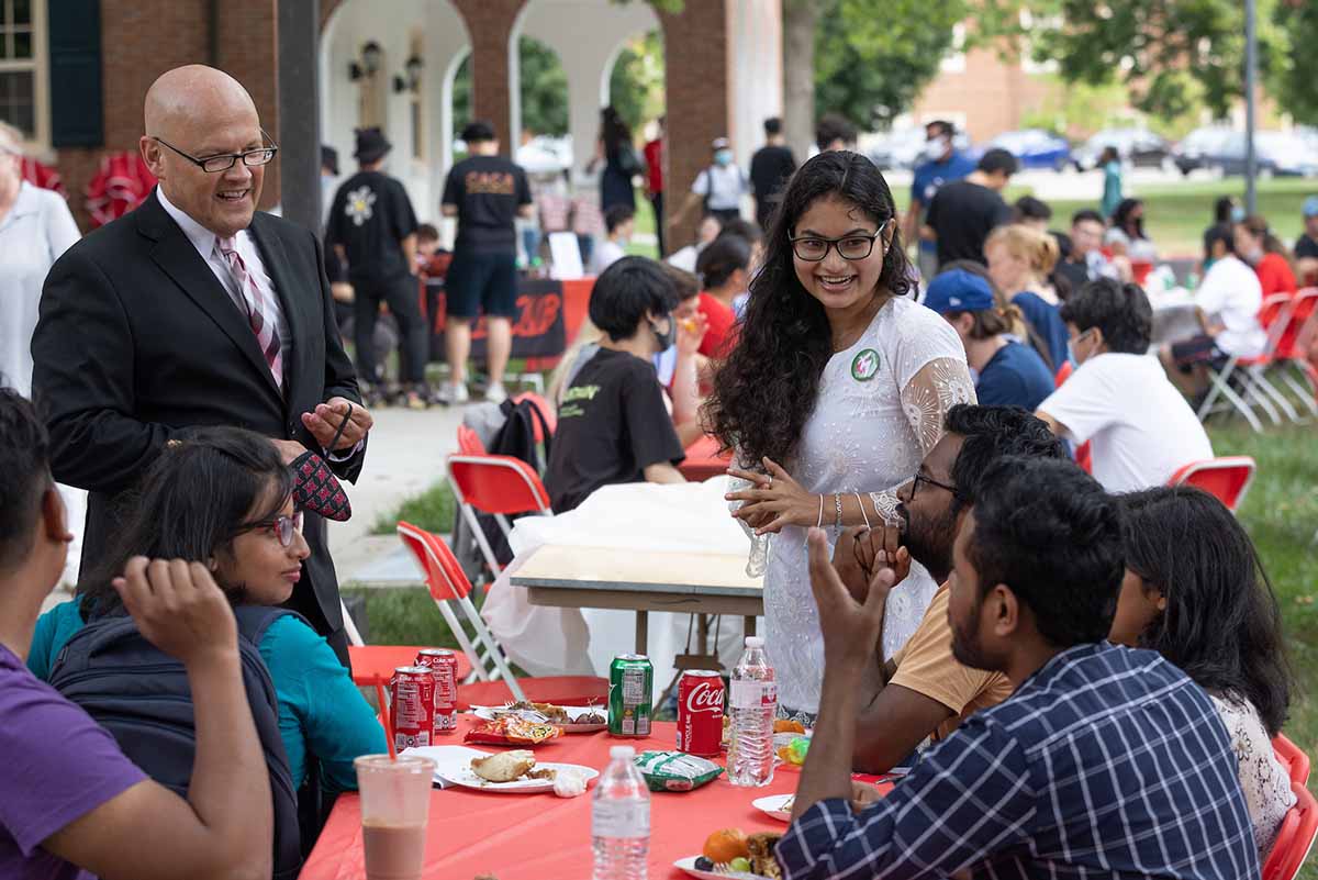 gregory crawford with international students at picnic