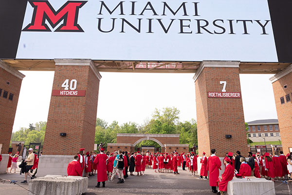 graduating students wait at Yager Stadium plaza before lining up to enter the stadium for spring commencement ceremony