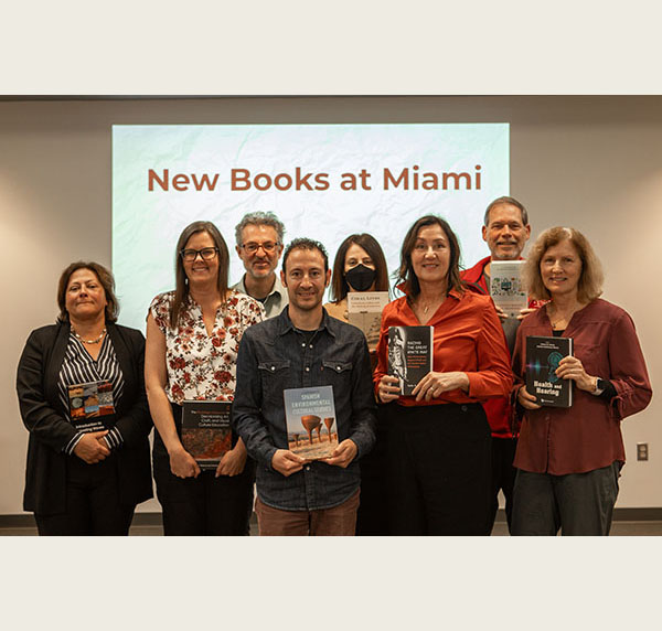 Several faculty members pose with their books published this year