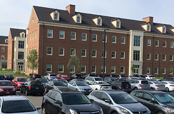 Cars in the parking lot near the Clinical Health Sciences and Wellness building
