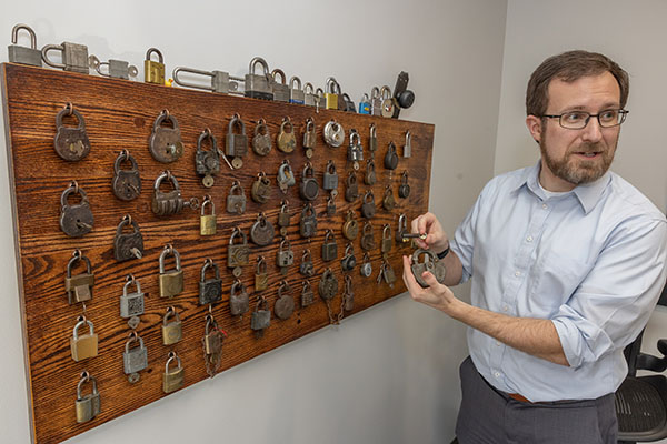 David Seidl, Miami University's vice president for information technology and chief information officer, looks at the collection of locks in his office.