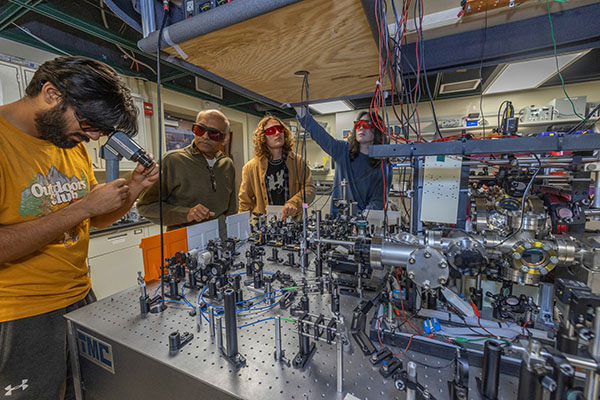 Samir Bali and three students in his Physics lab