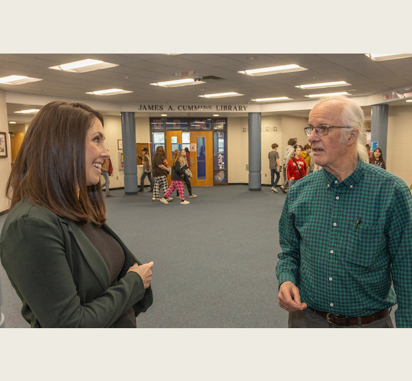 Union County Middle School Principal Monica Hofmann talks to Bill Renwick as students change classes