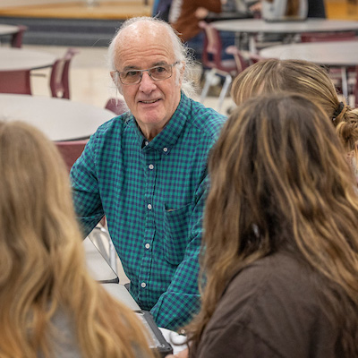 Bill Renwick talks to junior high students during a study hall period.
