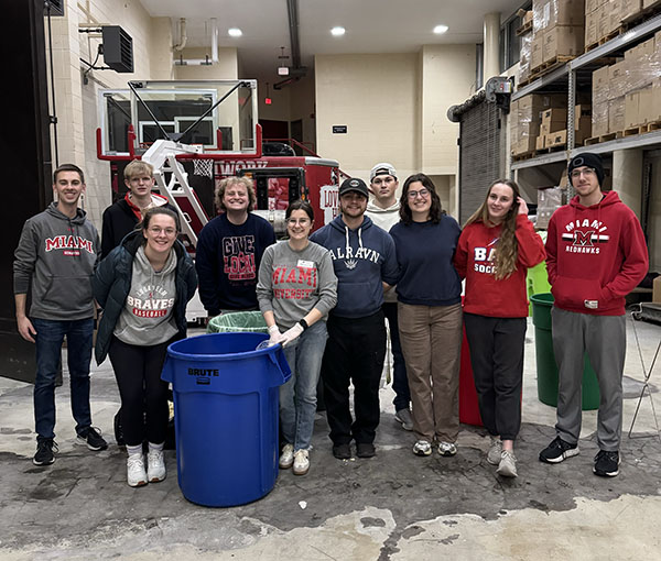 group of students weigh the waste