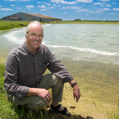 Bill Renwick crouches near a lake when he worked at Miami University.