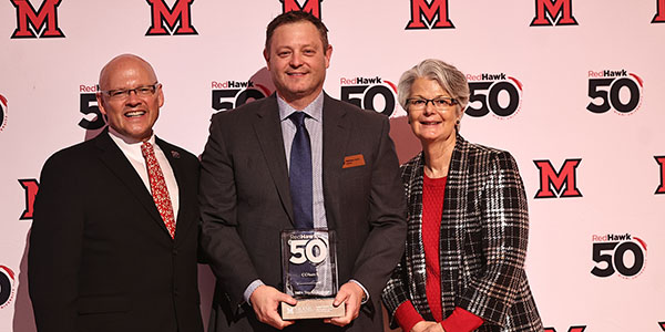 Miami University President Gregory Crawford, alumnus Matthew Davis '99, and Farmer School of Business dean Jenny Darroch
