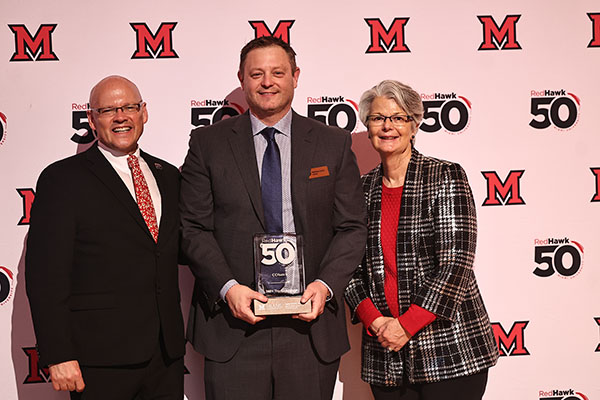 Miami University President Gregory Crawford, alumnus Matthew Davis '99, and Farmer School of Business dean Jenny Darroch