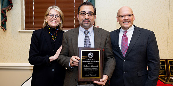 Miami University provost Elizabeth Mullenix, left, Hakam Alomari, and Miami President Gregory Crawford