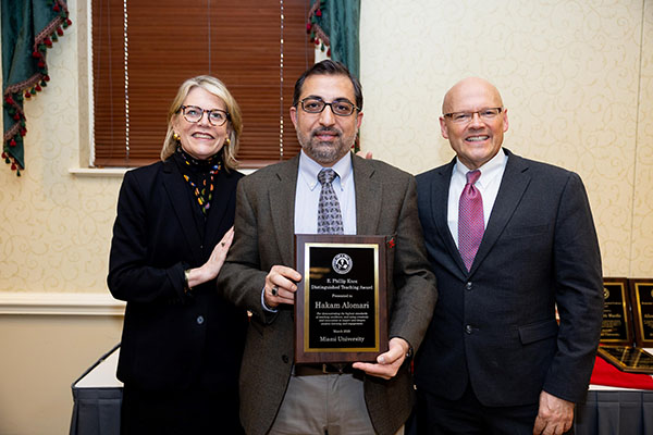 Miami University provost Elizabeth Mullenix, left, Hakam Alomari, and Miami President Gregory Crawford