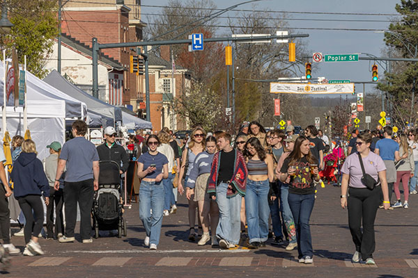 A group of people walk down High Street during the Oxford Bee Festival