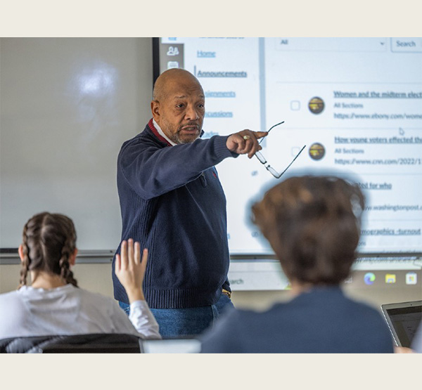 Rodney Coates gestures while talking to students in the classroom