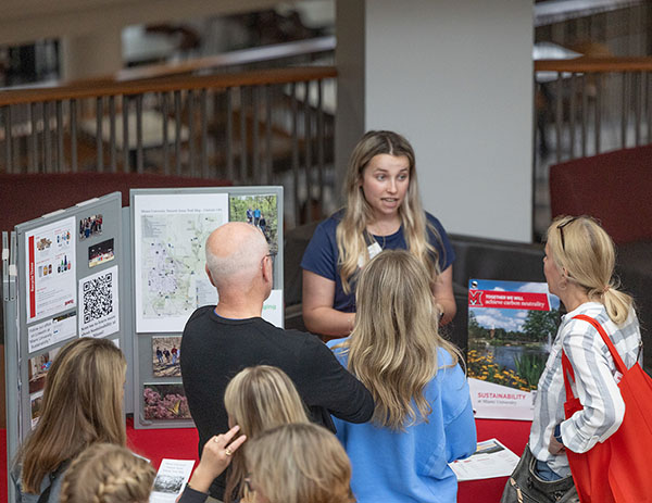 Alex Miller talks with parents at Summer Orientation resource fair
