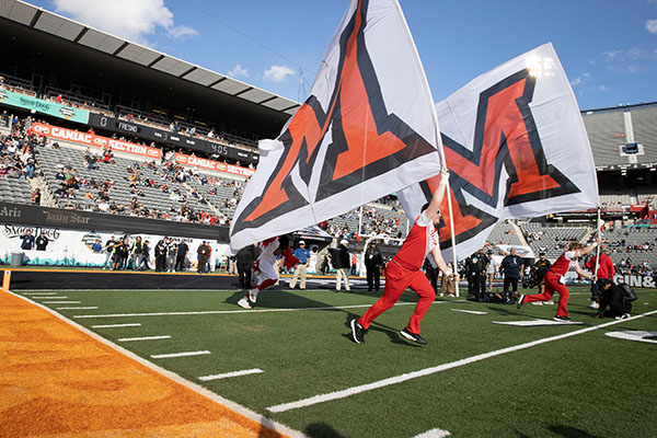 Miami University students with Miami flag at Arizona Bowl