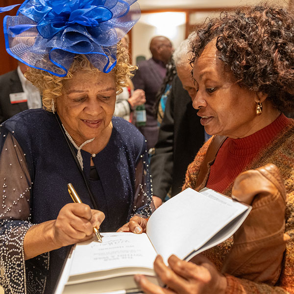 Dorothy Harris signs a book