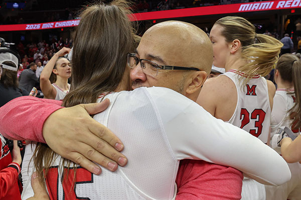 Miami's Amber Tretter (15) and coach Glenn Box
