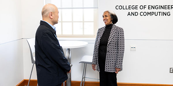 Beena Sukumaran, the Dinesh and Ila Paliwal Dean of the College of Engineering and Computing, right, talks with Liran Ma, chair of the Department of Computer Science and Software Engineering.