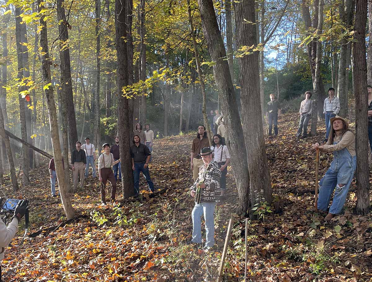 During filming of the music video, members of the Miami University Men's Glee Club pose on a hillside covered with autumn leaves near the Marcum trail area of the Miami University Natural Areas (photo by Jeremy D. Jones)