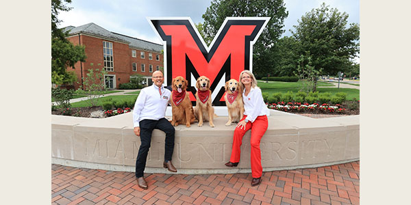 President Gregory Crawford and University Ambassador Dr. Renate Crawford with their dogs at RedHawk Plaza